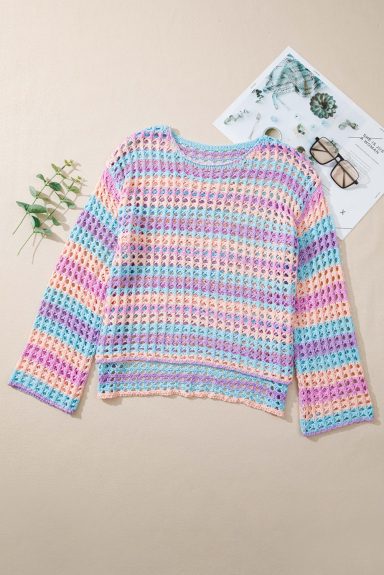 Multicoloured striped sweater with long sleeves, laid on a beige background.